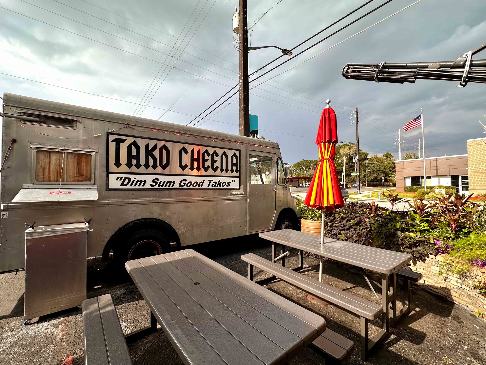 silver tako cheena branded food truck with metal tables